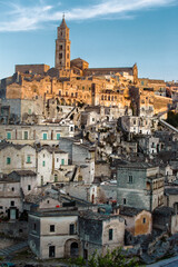 View of the Sasso Baritano with the famous Matera Cathedral of Maria Santissima della Bruna,  illuminated by the sunset light. Matera, Basilicata, Italy.