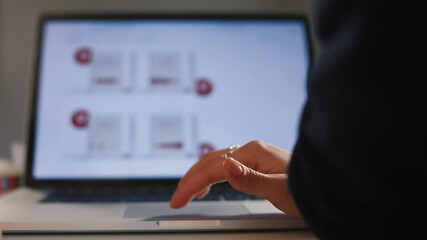 A hand uses a touchpad on a laptop in the office to demonstrate business development graph. Against background, the picture is moving in monitor bokeh. Computer control by pressing your finger. - Powered by Adobe