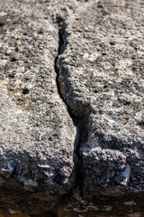 Deep crack in the big rock of the wall of a castle
