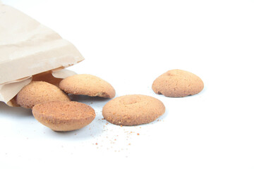 oatmeal cookies and brown kraft paper bag on white background