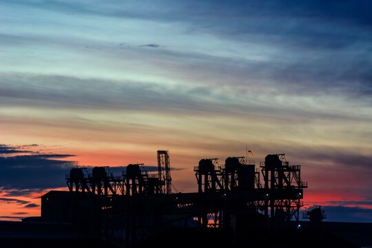 Sunrise In Santos, Near The Port With Silhouette Of Cranes.