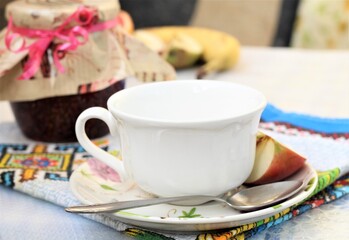 white cup of tea and apple
