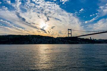 Turkey, Istambul - 21 April 2019 - A pylon of the 15 July Martyrs Bridge and glimpse of Istanbul at sunset