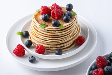 Traditional Russian pancakes with berries. Maslenitsa week. Pancake week..