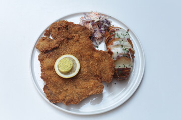 Chicken on the white plate with vegetables