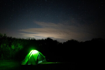 Stars in sky with enlighten camping tent - Astrophotography