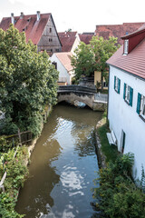 Fototapeta na wymiar Lonely little bridge across the river at the medieval old town