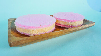 Arum Manis. Traditional sweet snack of cotton candy floss sandwich from Indonesia. Served on wooden plate