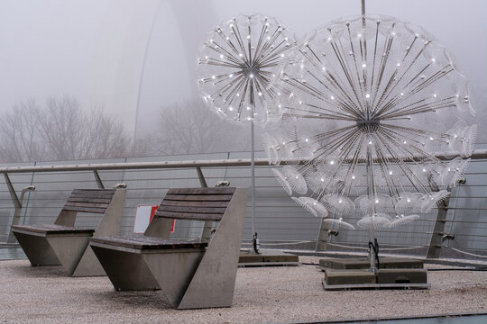 Two benches and street lights decoration similar to iron dandelion flowers