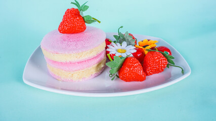 Cirebon - December 31, 2020 - Traditional Snack from Indonesia as known Rambut Nenek or Arbanat, is a snack made from sugar. served on white plate and strawberries