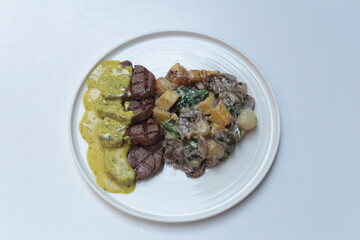 Grilled pork with vegetables on the white plate