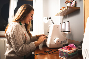 Young woman using a sewing machine