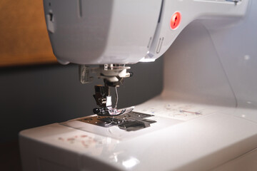 Hands working on a sewing machine