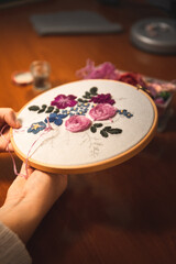 Young woman weaving a embroidery