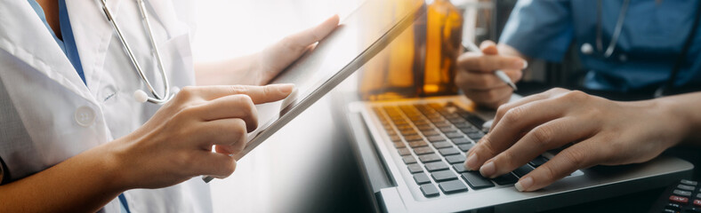 Medical technology concept The doctor works with mobile phones, headphones and tablets. Digital laptop Pressing the calculator in the modern office at the hospital in the morning