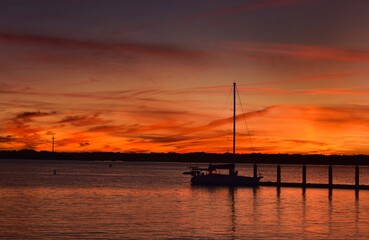 Fototapeta na wymiar Sailboat Silhouette at Sunset in Saint Augustine Florida