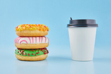 Sweet donut or doughnut with hot cup of fresh brewed coffee or tea. Takeaway paper cup with donuts....