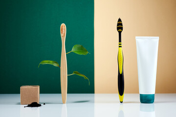 Zero waste, Eco-friendly creative concept. Wooden bamboo toothbrush with leaves VS plastic brush....