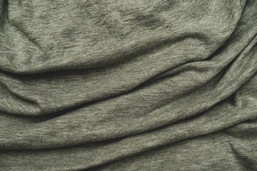 Pleats on the gray cotton fabric. The crumpled grey fabric