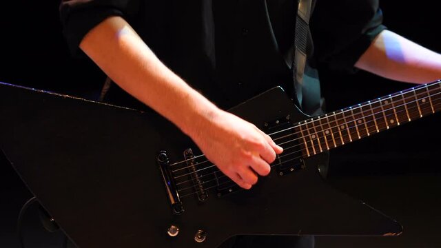 Unrecognizable musician playing the electric guitar during a live performance