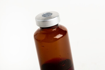 Macro Image Of Amber Vaccine Vial In White Background