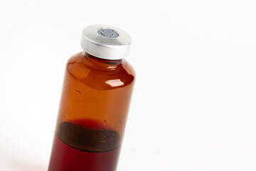 Macro Image Of Amber Vaccine Vial In White Background