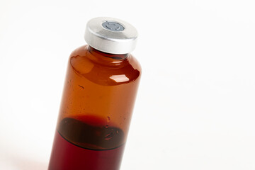 Macro Image Of Amber Vaccine Vial In White Background