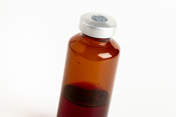 Macro Image Of Amber Vaccine Vial In White Background