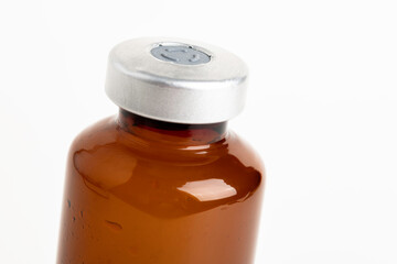 Macro Image Of Amber Vaccine Vial In White Background