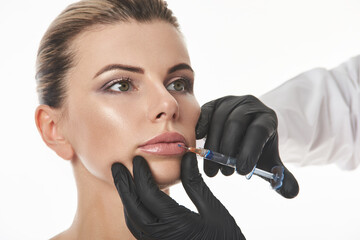 Attractive woman getting cosmetic injection on lips. Lips augmentation and correction concept