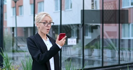 A business woman receives a message on her phone in the form of a success growth graph, the woman is very surprised and happy. The video contains infographics. - Powered by Adobe