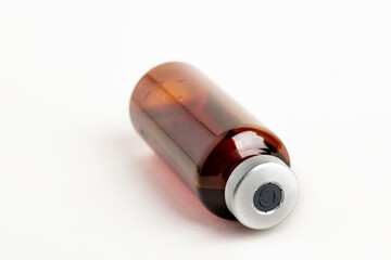 Macro Image Of Amber Vaccine Vial In White Background