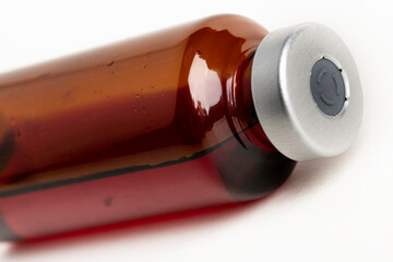 Macro Image Of Amber Vaccine Vial In White Background