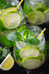 Refreshing summer alcoholic cocktail mojito with ice, fresh mint and lime.