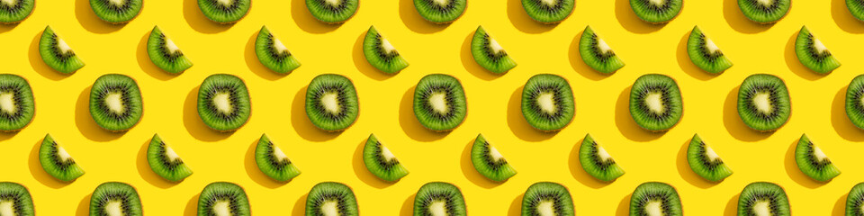 Fototapeta premium Kiwi seamless pattern on a yellow background.