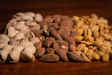 Pattern of pistachios, almonds, peanuts on wood table