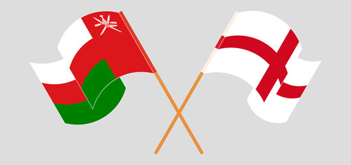 Crossed and waving flags of Oman and England