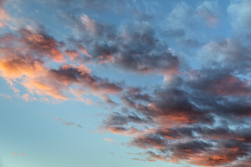 A beautiful sunset paints fluffy clouds in colorful warm tones with a deep blue evening sky background over Indiana.