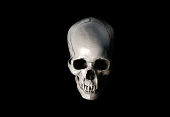 Human skull with an open lower jaw on a Black isolated background. The concept of death, immortality, eternal life, horror. Acult symbol. Spooky Halloween symbol. 3D render