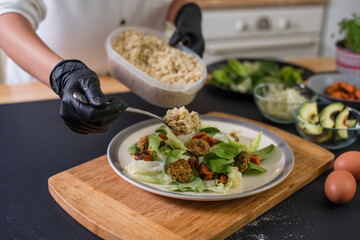 Female chef places finishing touches on meal
