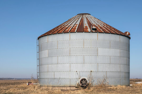 Corrugated Metal Silo with Rust by a Farm Field