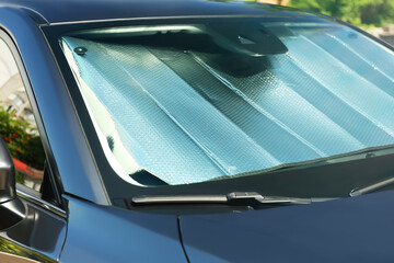 Sun shade under windshield inside car, closeup. Heat protection