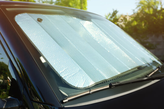 Sun shade under windshield inside car, closeup. Heat protection