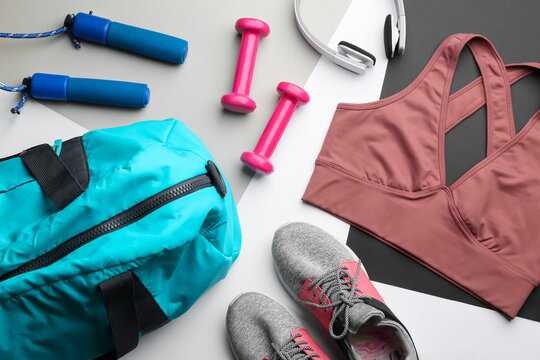 Flat lay composition with gym bag and sportswear on light grey background