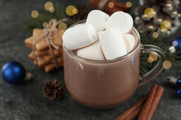 Obraz na płótnie Canvas Delicious cocoa drink with marshmallows and Christmas decor on grey table, closeup