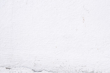 The white cement wall had a broken rail at the bottom.