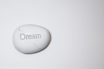 Egg shaped stone with a word 