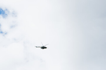 Naklejka na ściany i meble helicopter on a background of blue sky with clouds