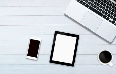 Top view over the tablet on white office style wooden floor.