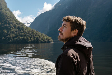 Fototapeta premium Caucasian man enjoying trip in Milford Sound Cruise. Fiordland National Park, New Zealand